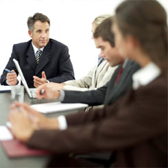 Business people discussing calculators